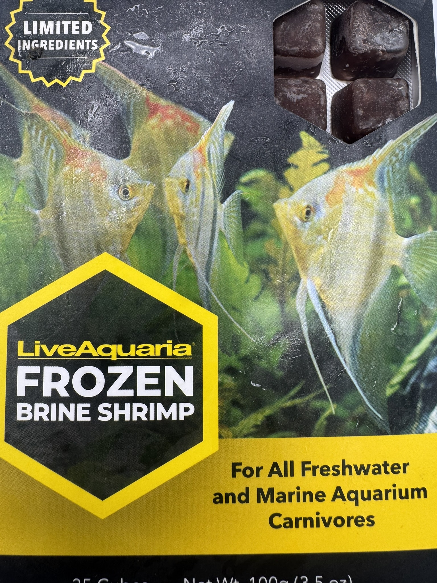 LiveAquaria Frozen Brine Shrimp 100 g (3.5 oz) frozen fish food package with frozen cubes and angelfish.